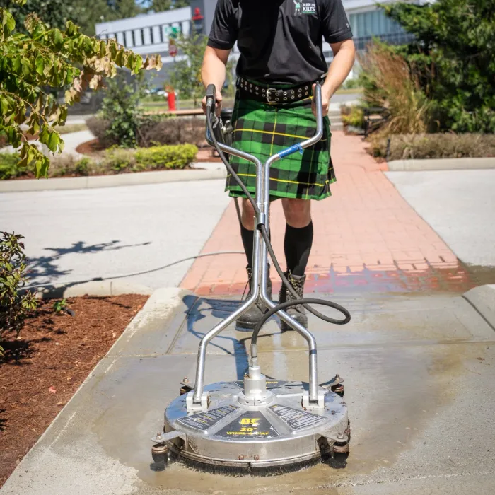 a man wearing a kilt and standing on a shopping cart